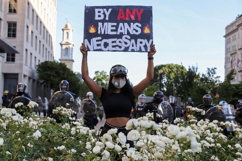 A demonstrator holds a placard during a protests against the death in Minneapolis custody of George Floyd, near the White House in Washington, D.C., U.S., June 1, 2020. (Photo by Jonathan Ernst/Reuters)